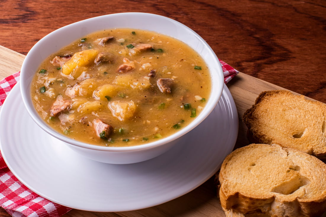 Cassava broth. Creamy broth made with cassava, sausage, bacon and meat. "Accompanied by toast