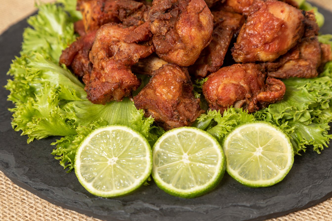 Portion of fried chicken on black stone plate